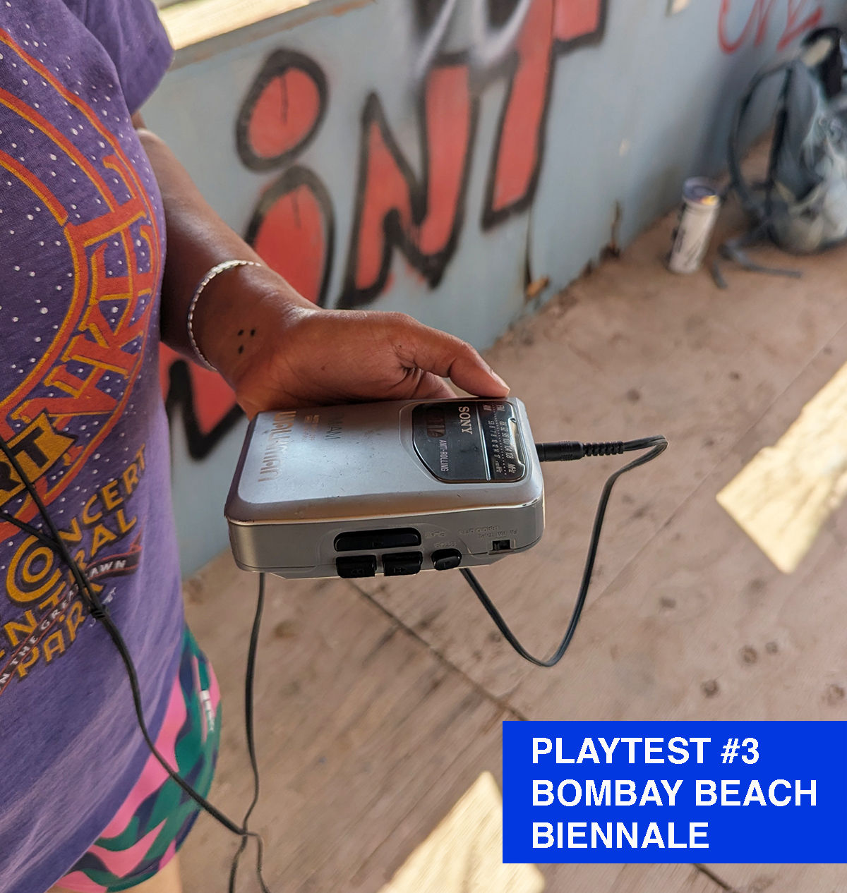 A woman holding a vintage walkman